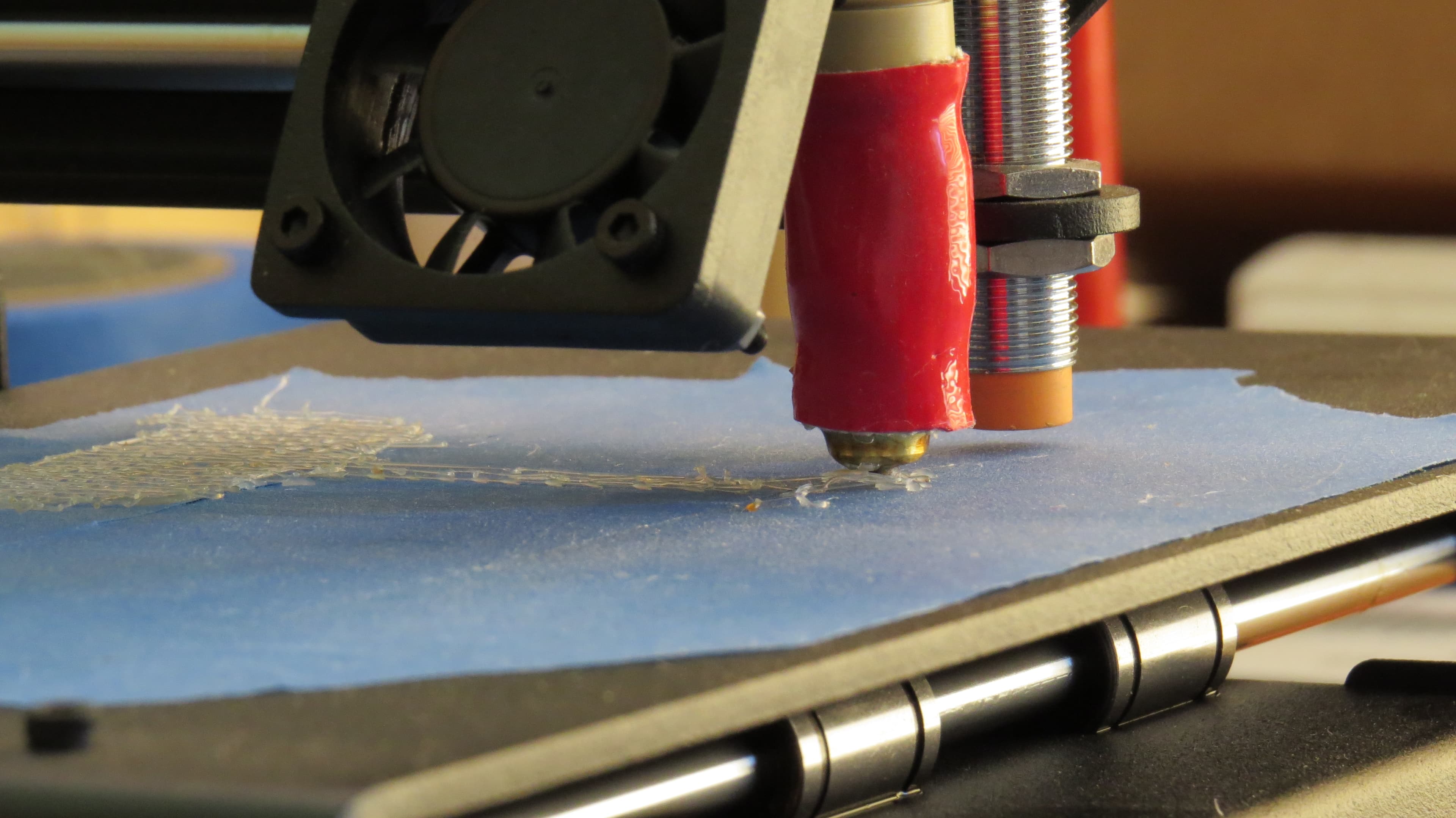 Close-up of a 3D printer laying down an early first layer.